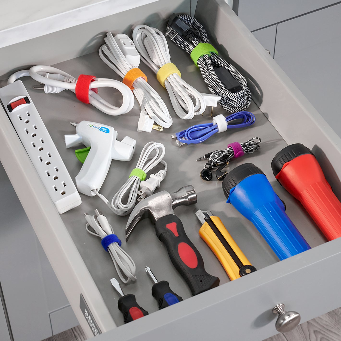 cords and wrap-it products laying inside of grey drawer
