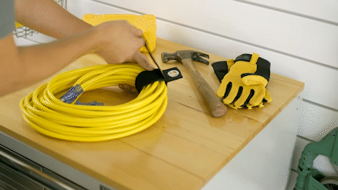 gif of Heavy-Duty Wrap-It Storage Straps wrapping extension cord and hanging