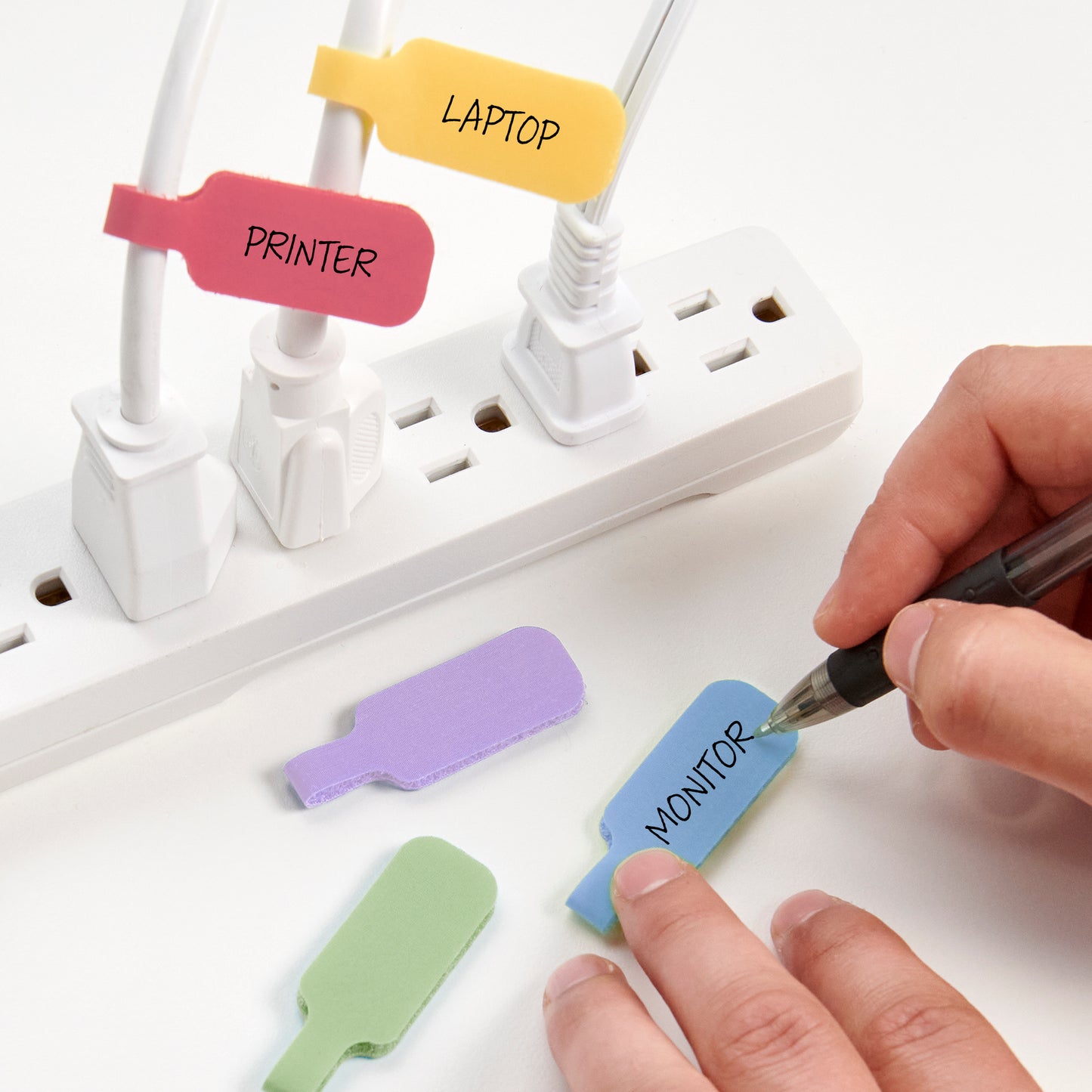 Easy to write on Macaron Cable Labels being attached to power strip for cable management